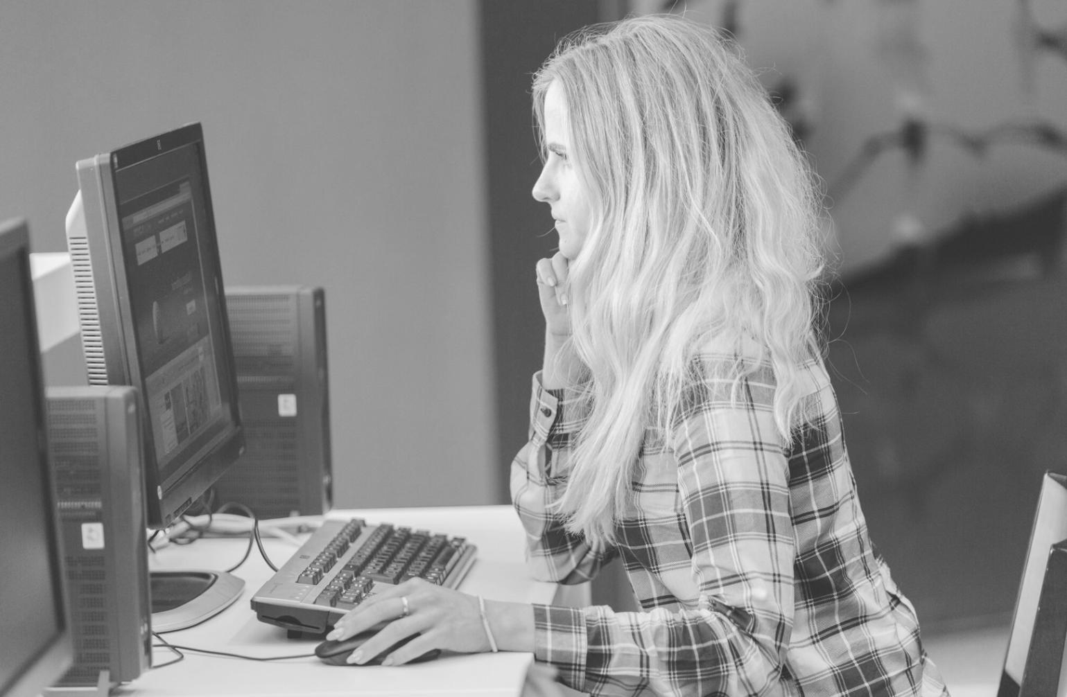 Person reviewing financial documents with calculator and notebook on desk