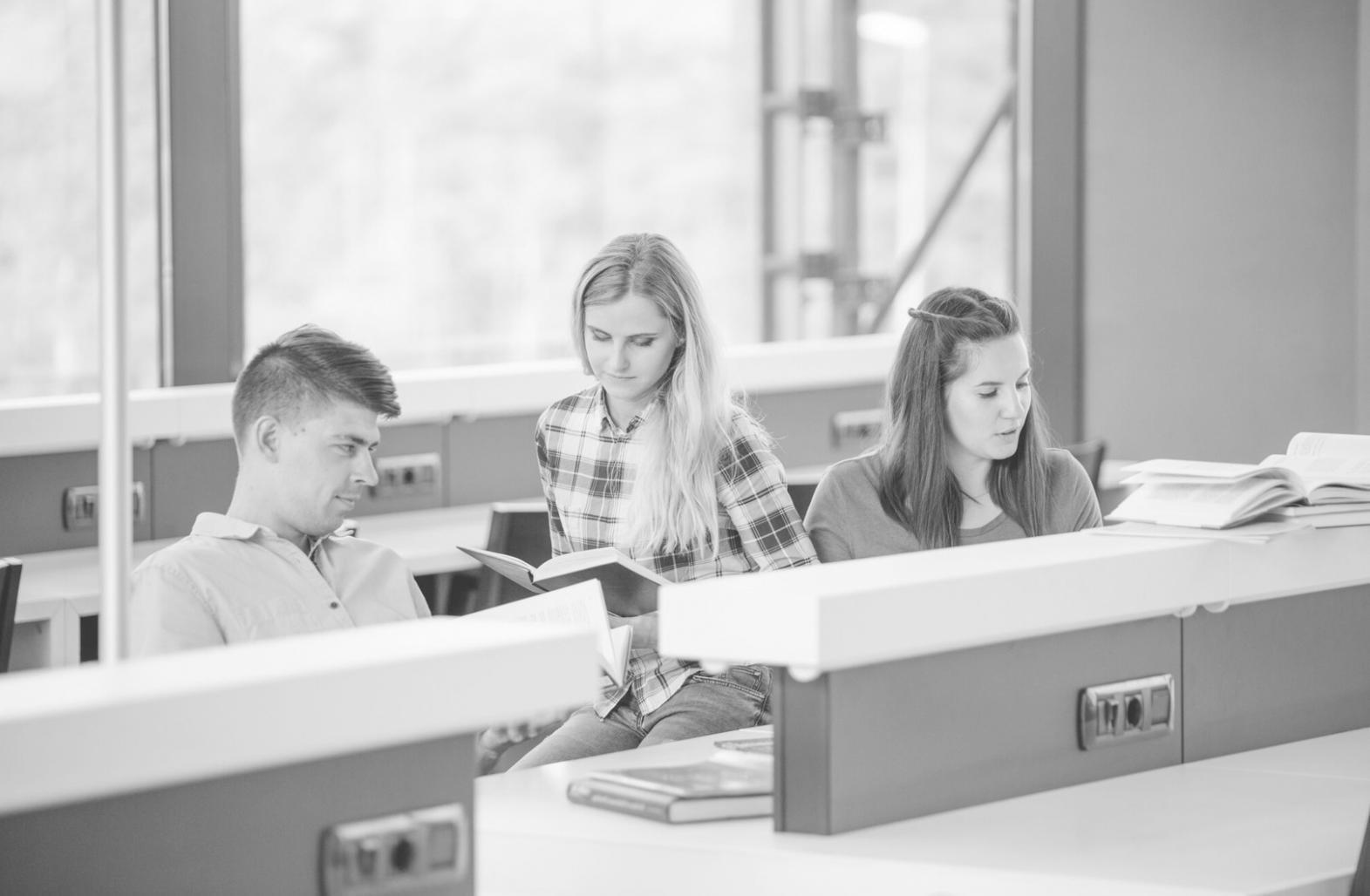Students learning budgeting techniques in collaborative workshop environment